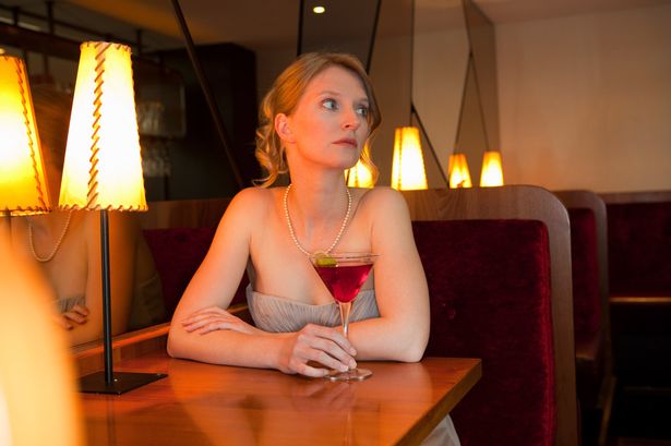 Woman-having-drink-at-restaurant